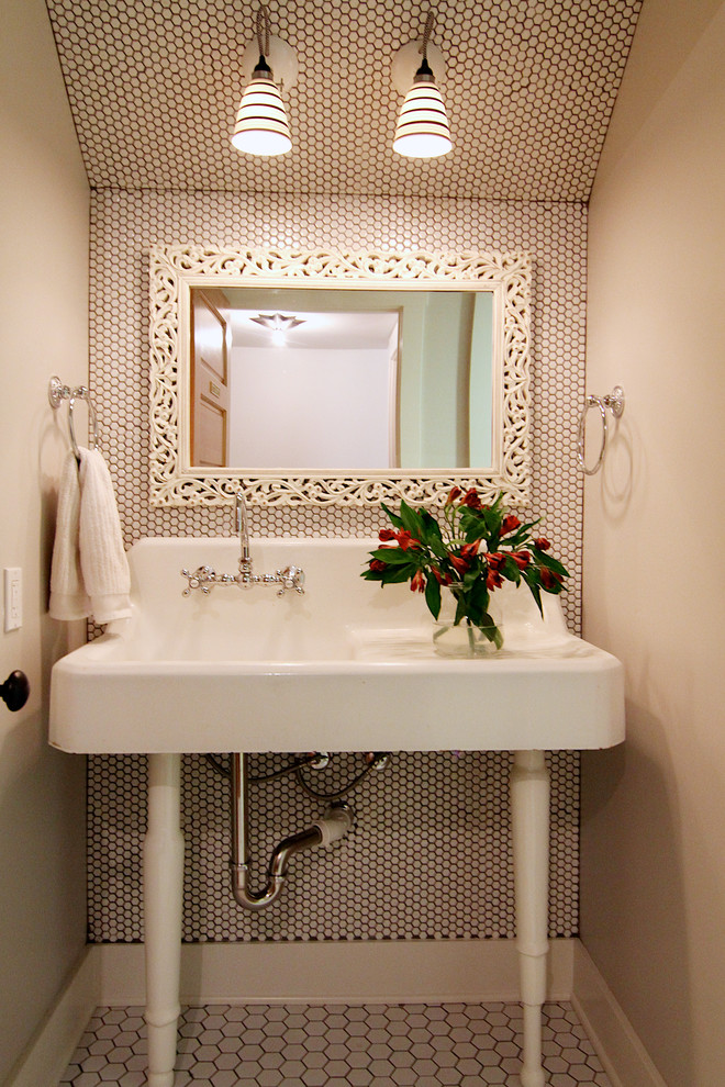 Elegant powder room photo in Other with a console sink and beige walls