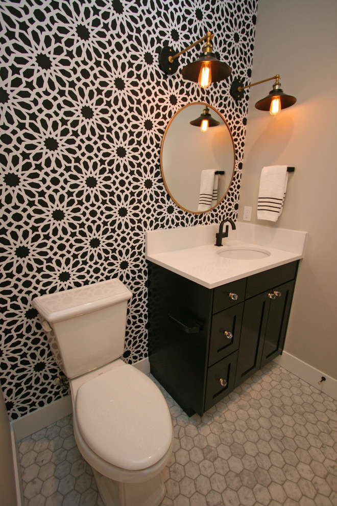 Photo of a small contemporary cloakroom in Seattle with shaker cabinets, black cabinets, a two-piece toilet, stone tiles, grey walls, mosaic tile flooring, a submerged sink, engineered stone worktops, white tiles and grey floors.