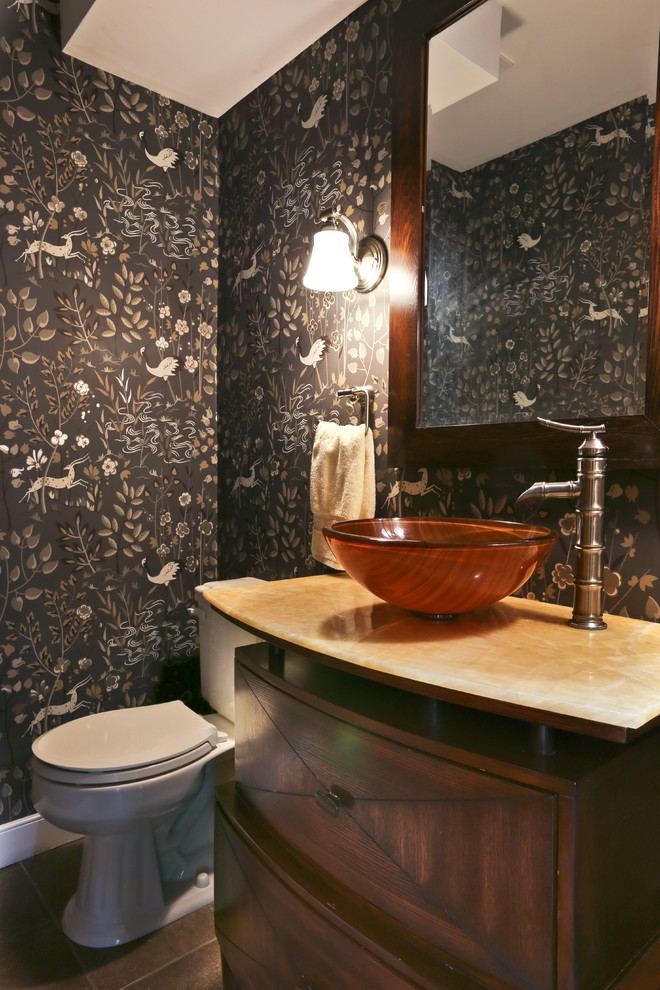 Idéer för mellanstora eklektiska toaletter, med släta luckor, skåp i mörkt trä, en toalettstol med hel cisternkåpa, svarta väggar, klinkergolv i keramik, ett fristående handfat, bänkskiva i kalksten och grått golv