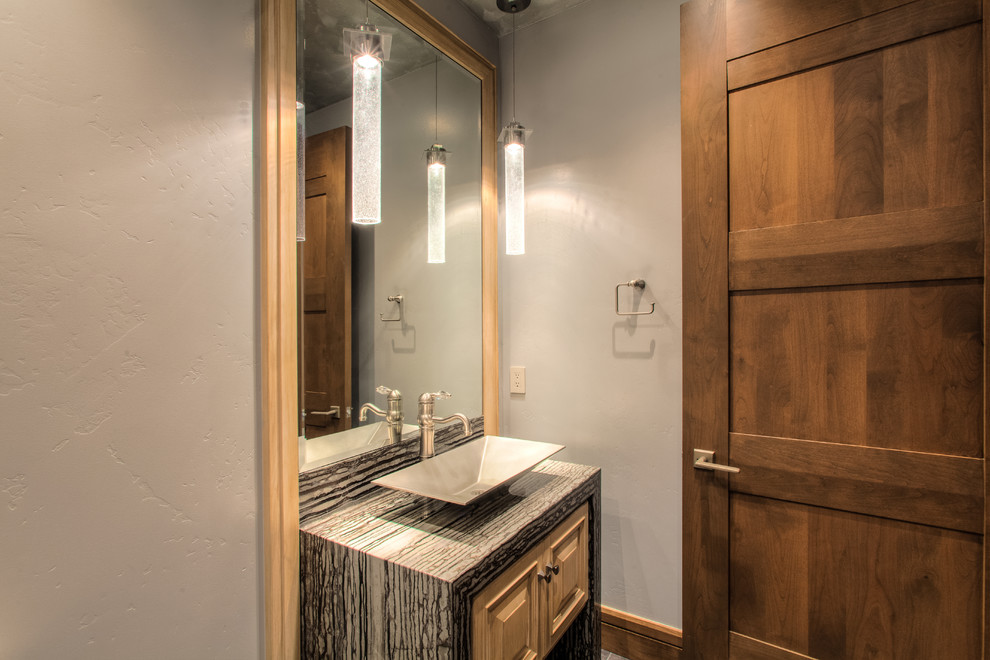 Design ideas for a small classic cloakroom in Seattle with freestanding cabinets, light wood cabinets, a one-piece toilet, beige walls, limestone flooring, a vessel sink, marble worktops and beige floors.