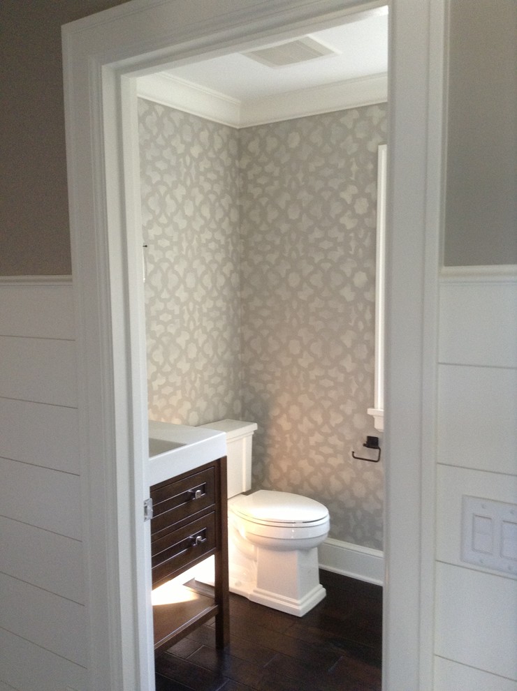 Transitional powder room photo in Grand Rapids with beige walls, furniture-like cabinets, dark wood cabinets, a two-piece toilet and an undermount sink