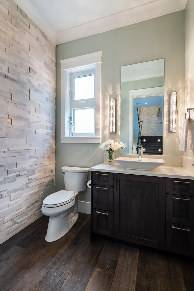 Small traditional cloakroom in Vancouver with shaker cabinets, brown cabinets, a two-piece toilet, grey tiles, marble tiles, grey walls, medium hardwood flooring, a vessel sink, engineered stone worktops, brown floors and beige worktops.