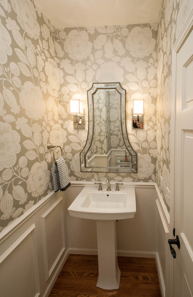 Example of a small classic medium tone wood floor powder room design in Minneapolis with a pedestal sink and beige walls