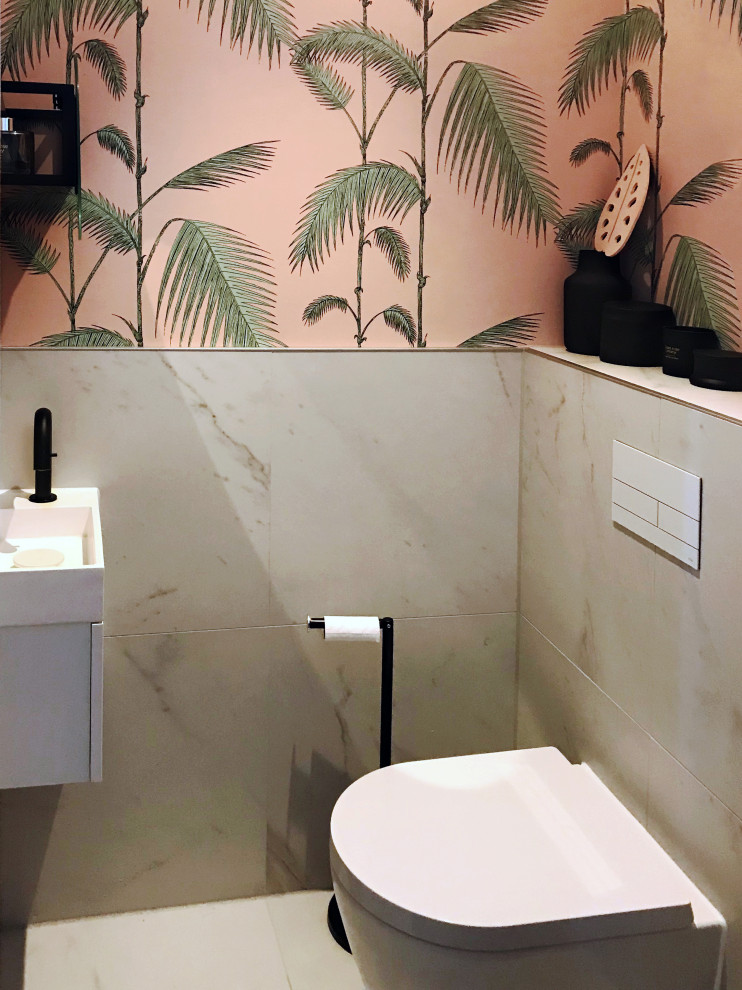 This is an example of a small modern cloakroom in Amsterdam with a wall mounted toilet, white tiles, ceramic tiles, pink walls, ceramic flooring, a wall-mounted sink and white floors.