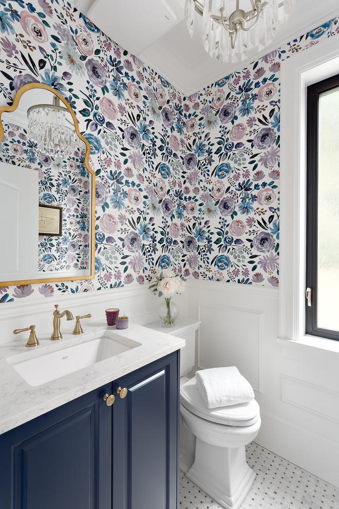 Inspiration for a small timeless mosaic tile floor and white floor powder room remodel in Vancouver with recessed-panel cabinets, blue cabinets, a two-piece toilet, an undermount sink, quartz countertops, white countertops and multicolored walls
