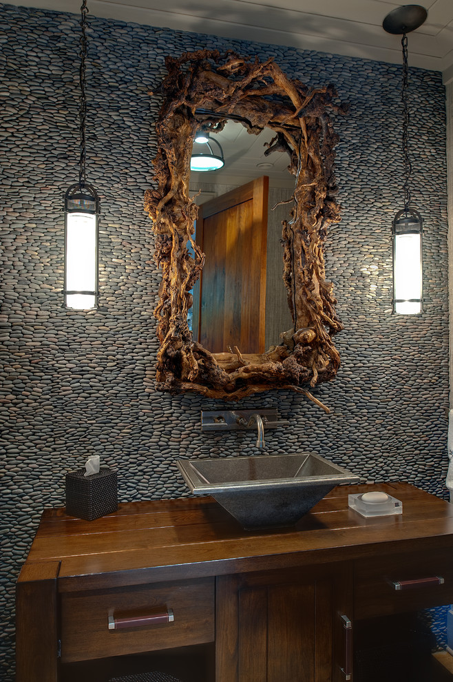 Example of a mountain style pebble tile powder room design in Atlanta with a vessel sink, wood countertops and brown countertops