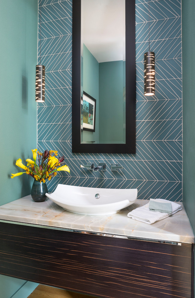 Inspiration for a contemporary cloakroom in Denver with flat-panel cabinets, dark wood cabinets, an urinal, blue tiles, glass tiles, blue walls, medium hardwood flooring, a vessel sink, brown floors and grey worktops.