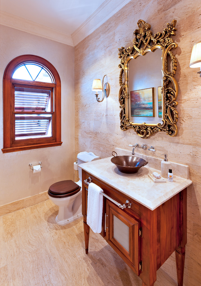 Example of a classic powder room design in Other with a vessel sink, furniture-like cabinets, medium tone wood cabinets and a two-piece toilet