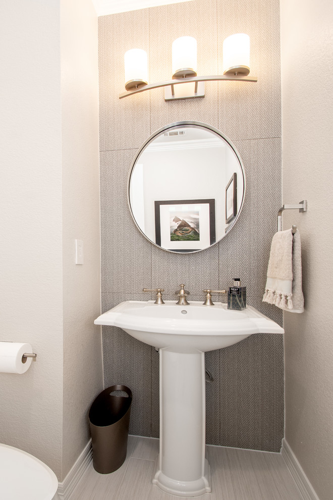 Inspiration for a small traditional cloakroom in Dallas with a two-piece toilet, grey tiles, ceramic tiles, grey walls, porcelain flooring, a pedestal sink and grey floors.