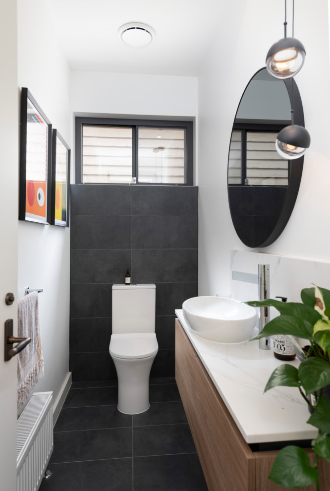Design ideas for a contemporary cloakroom in Melbourne with a two-piece toilet, white walls, porcelain flooring, a vessel sink, engineered stone worktops, grey floors and white worktops.