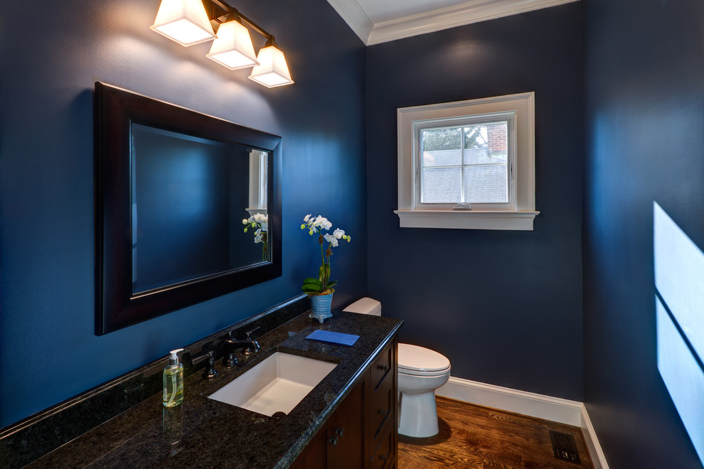 Esempio di un bagno di servizio tradizionale di medie dimensioni con ante in stile shaker, ante in legno bruno, pareti blu, parquet scuro, lavabo sottopiano, top in granito e pavimento marrone