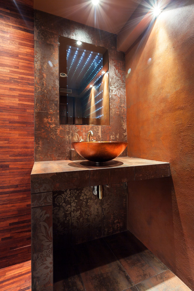 Example of a mid-sized zen multicolored tile and porcelain tile porcelain tile powder room design in Atlanta with a wall-mount toilet, orange walls and a vessel sink