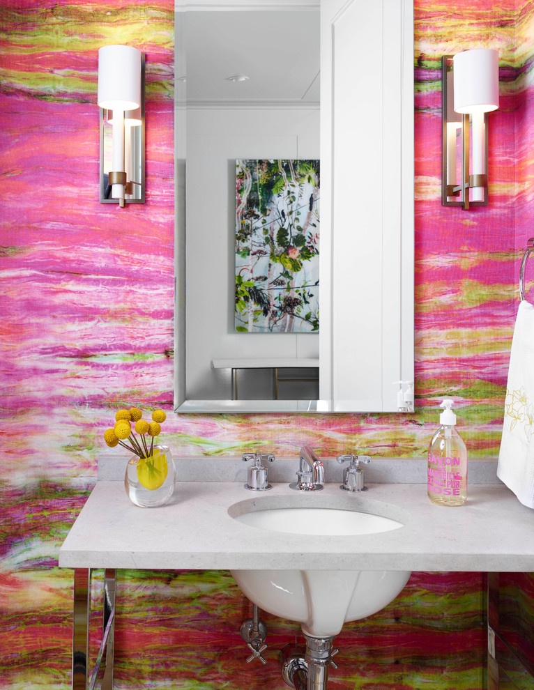 На фото: туалет в современном стиле с розовыми стенами, врезной раковиной и серой столешницей