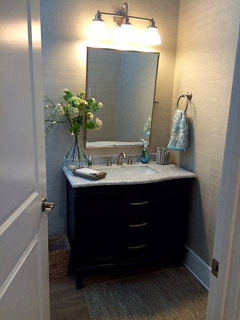 Photo of a small beach style cloakroom in Other with freestanding cabinets, dark wood cabinets, beige walls, dark hardwood flooring, a submerged sink, quartz worktops and brown floors.