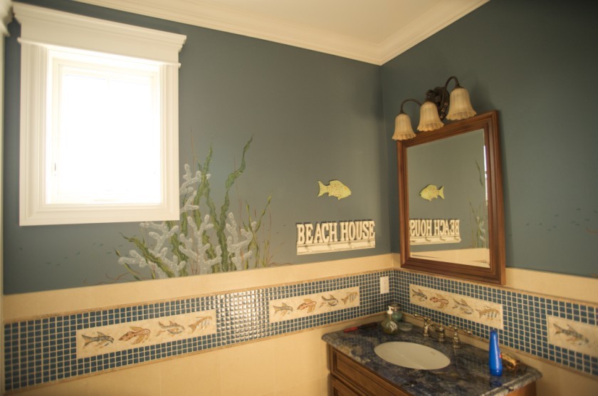 Small beach style blue tile and mosaic tile powder room photo in New York with medium tone wood cabinets, an undermount sink and granite countertops