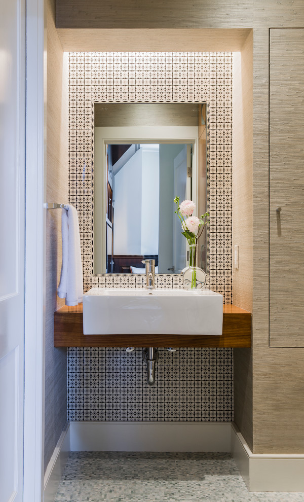 Small contemporary cloakroom in Boston with a vessel sink, wooden worktops, multi-coloured tiles, medium wood cabinets, ceramic tiles, beige walls, mosaic tile flooring, grey floors and brown worktops.