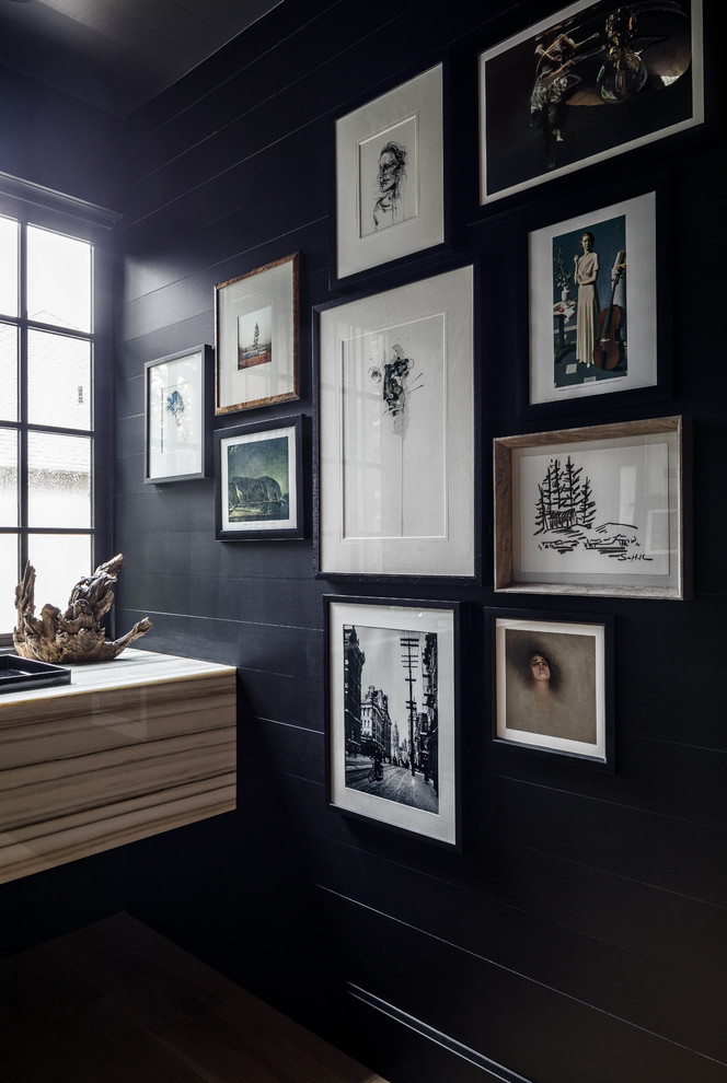 Inspiration for a contemporary cloakroom in Ottawa with a wall mounted toilet, black tiles, black walls and light hardwood flooring.