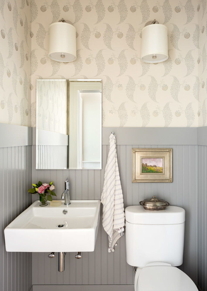 Example of a small classic powder room design in Other with a two-piece toilet, multicolored walls and a wall-mount sink
