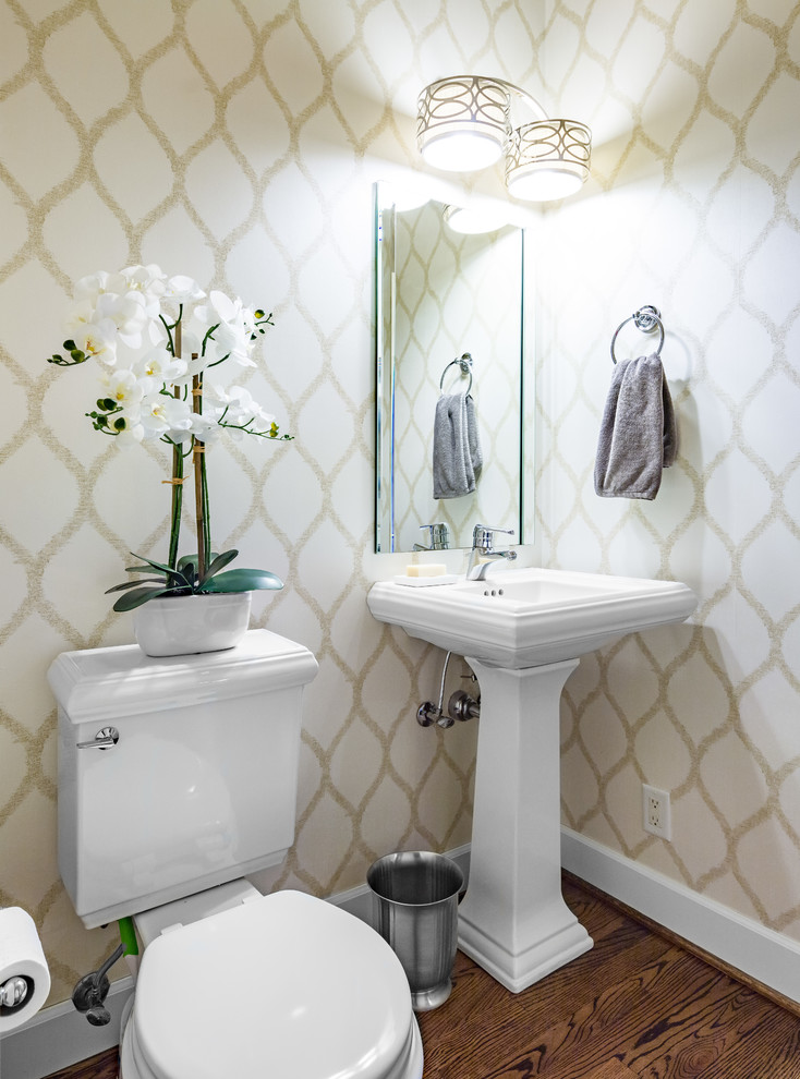 Photo of a medium sized classic cloakroom in Other with a two-piece toilet, beige walls, dark hardwood flooring, a pedestal sink and brown floors.