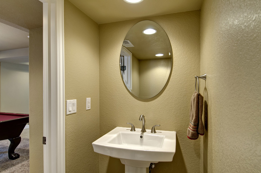 Small elegant powder room photo in Denver with beige walls and a pedestal sink