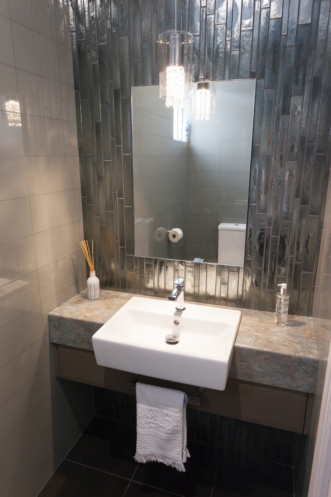 Example of a minimalist gray tile and ceramic tile powder room design in Perth with brown cabinets, laminate countertops, flat-panel cabinets, multicolored countertops and a pedestal sink