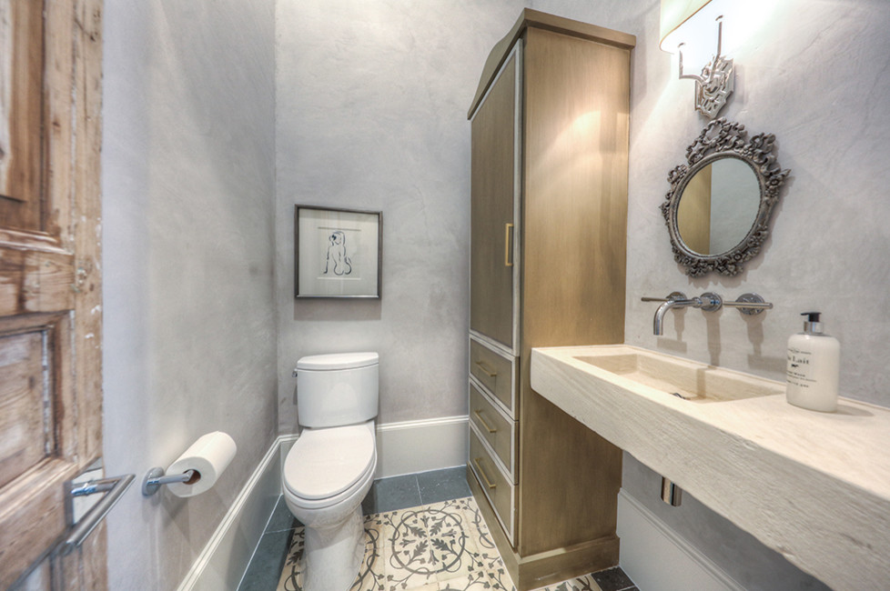 Photo of a medium sized traditional cloakroom in Houston with flat-panel cabinets, medium wood cabinets, a two-piece toilet, grey walls, slate flooring and an integrated sink.