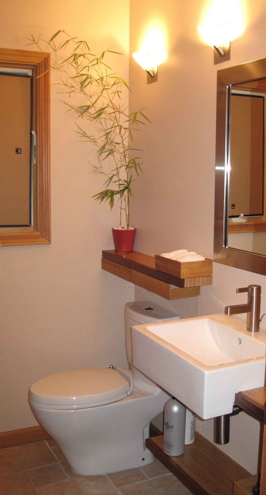 Example of a small ceramic tile powder room design in San Francisco with a vessel sink, open cabinets, a two-piece toilet, beige walls, wood countertops and brown countertops