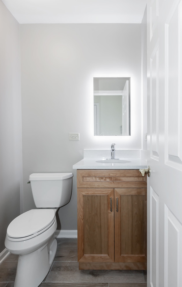 Источник вдохновения для домашнего уюта: маленький туалет в стиле неоклассика (современная классика) с фасадами с выступающей филенкой, светлыми деревянными фасадами, серыми стенами, врезной раковиной и серым полом для на участке и в саду