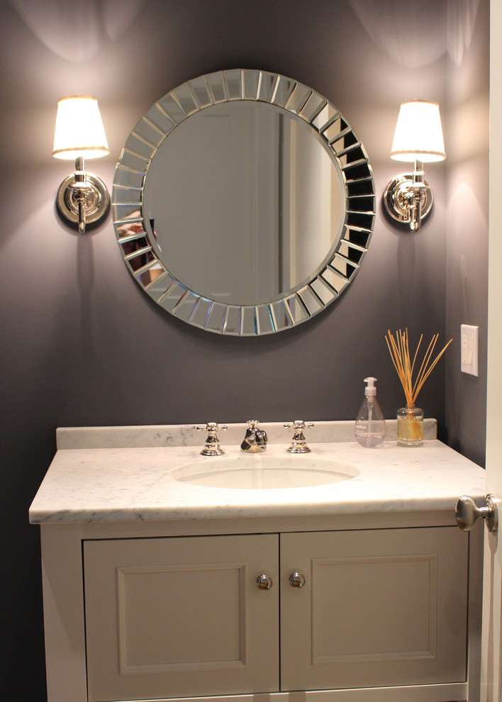 Inspiration for a mid-sized transitional powder room remodel in New York with beige cabinets, purple walls, an undermount sink, marble countertops, beaded inset cabinets and white countertops