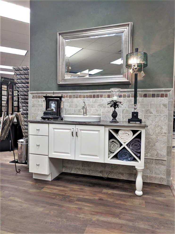 Powder room - small transitional green tile and porcelain tile laminate floor and brown floor powder room idea in Denver with furniture-like cabinets, white cabinets, green walls, a vessel sink, granite countertops and multicolored countertops