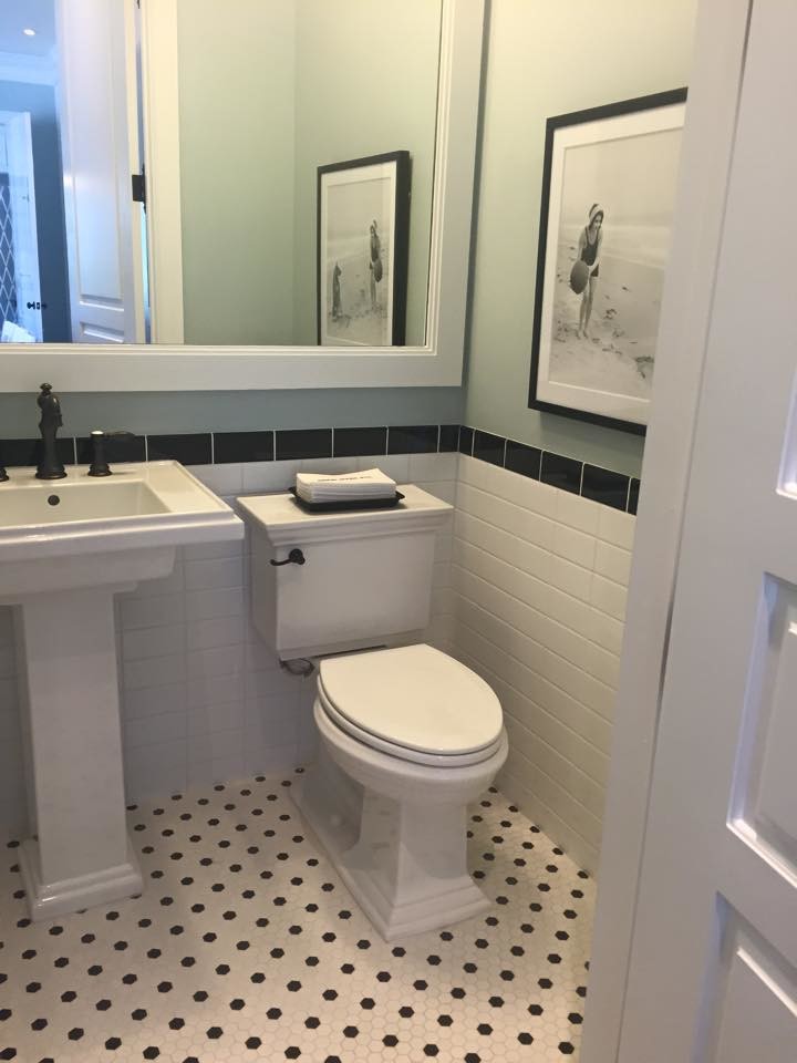 This is an example of a medium sized classic cloakroom in Tampa with a two-piece toilet, black and white tiles, metro tiles, blue walls, mosaic tile flooring, a pedestal sink, solid surface worktops and multi-coloured floors.