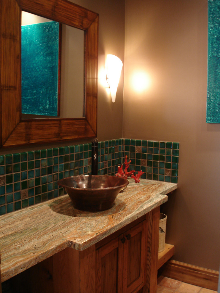 Elegant green tile and ceramic tile powder room photo in Los Angeles with recessed-panel cabinets, medium tone wood cabinets, a vessel sink and onyx countertops