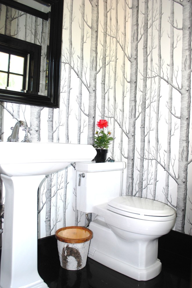 Mid-sized trendy dark wood floor powder room photo in Boston with a pedestal sink, multicolored walls and solid surface countertops