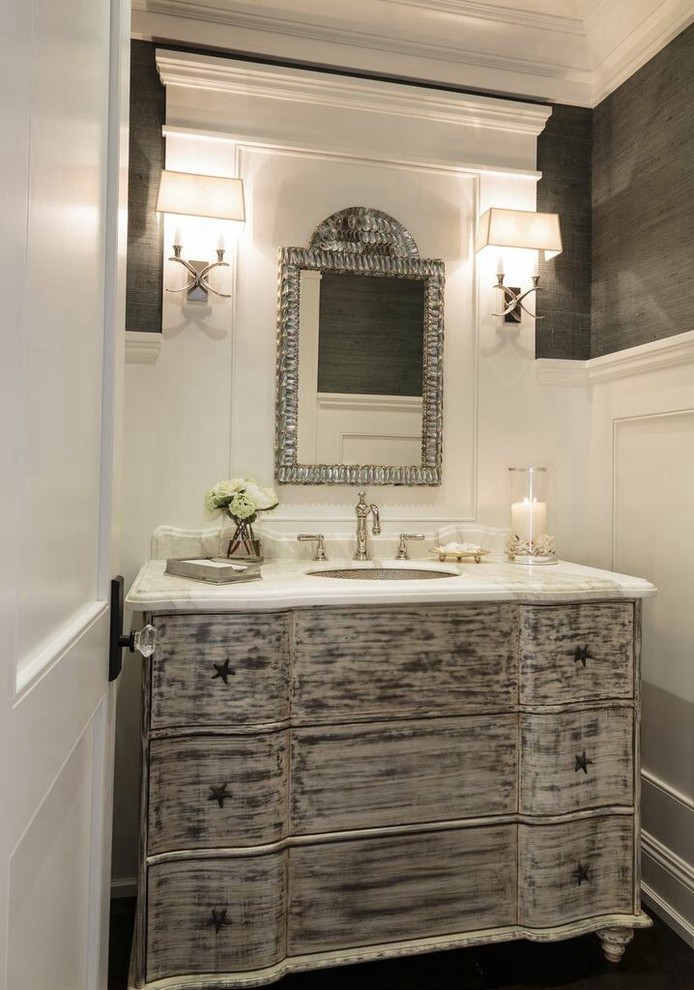 Inspiration for a coastal dark wood floor powder room remodel in Orange County with an undermount sink, furniture-like cabinets, distressed cabinets, gray walls and white countertops
