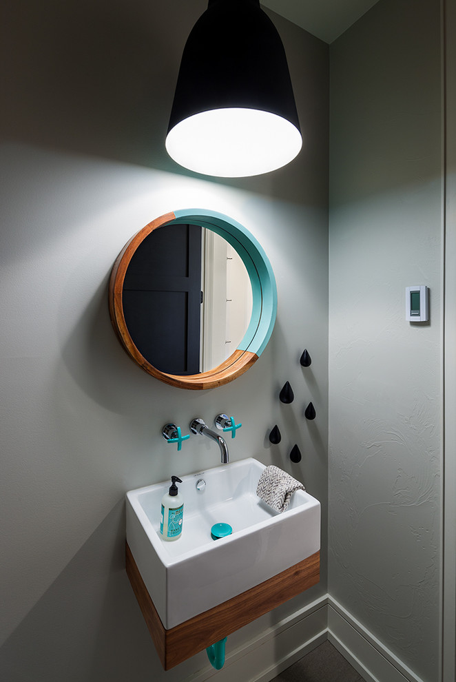 Design ideas for a small contemporary cloakroom in Other with a wall-mounted sink, grey walls, flat-panel cabinets and medium wood cabinets.