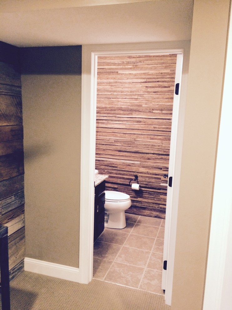 This is an example of a small rustic cloakroom in Columbus with dark wood cabinets, a one-piece toilet, brown tiles, brown walls, ceramic flooring, a vessel sink, granite worktops and brown floors.