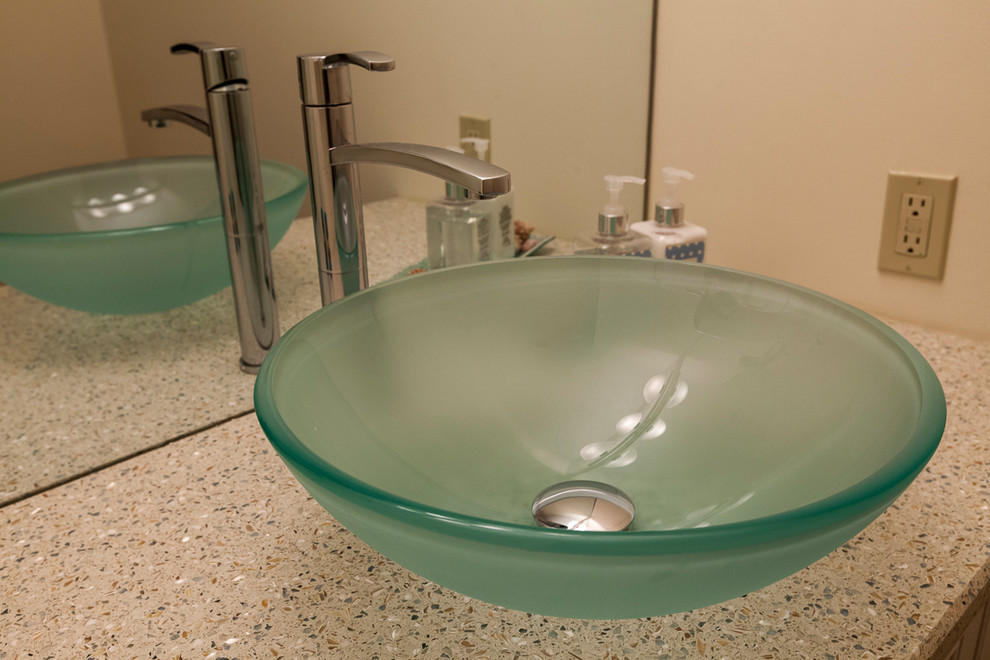 Example of a small beach style powder room design in Bridgeport with a vessel sink, recycled glass countertops, a two-piece toilet and beige walls