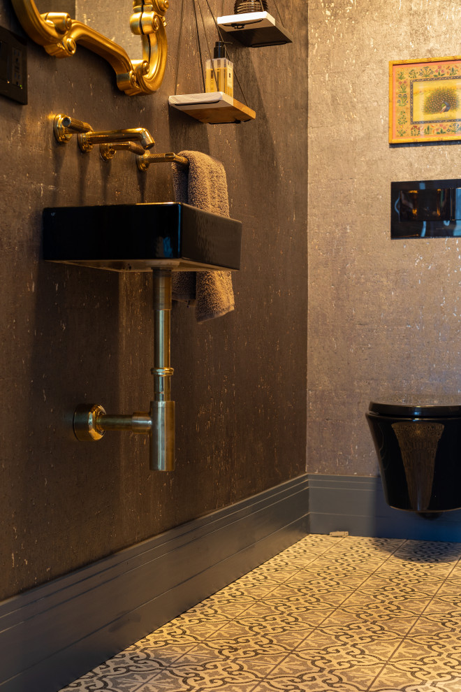 Small traditional cloakroom in Denver with a wall mounted toilet, brown tiles, porcelain tiles, brown walls, cement flooring, a wall-mounted sink and multi-coloured floors.