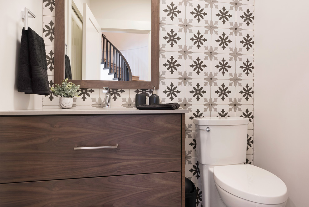 This is an example of a small classic cloakroom in Vancouver with flat-panel cabinets, dark wood cabinets, a one-piece toilet, multi-coloured tiles, ceramic tiles, white walls, vinyl flooring, a submerged sink, engineered stone worktops, beige floors and grey worktops.