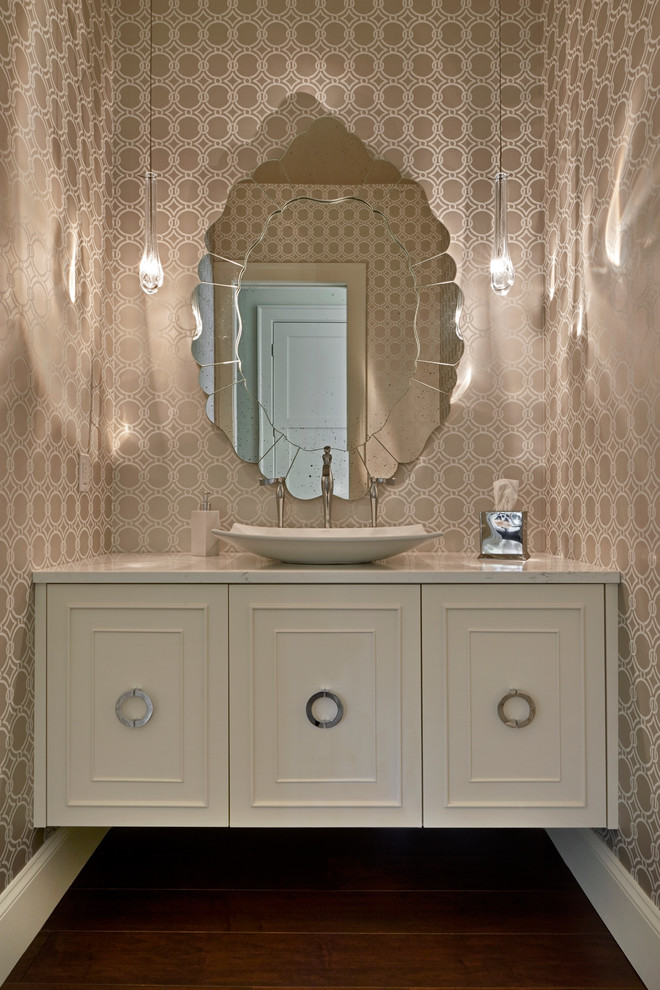 Powder room - mid-sized transitional stone slab dark wood floor powder room idea in Phoenix with beaded inset cabinets, white cabinets, beige walls, a vessel sink, marble countertops and a wall-mount toilet