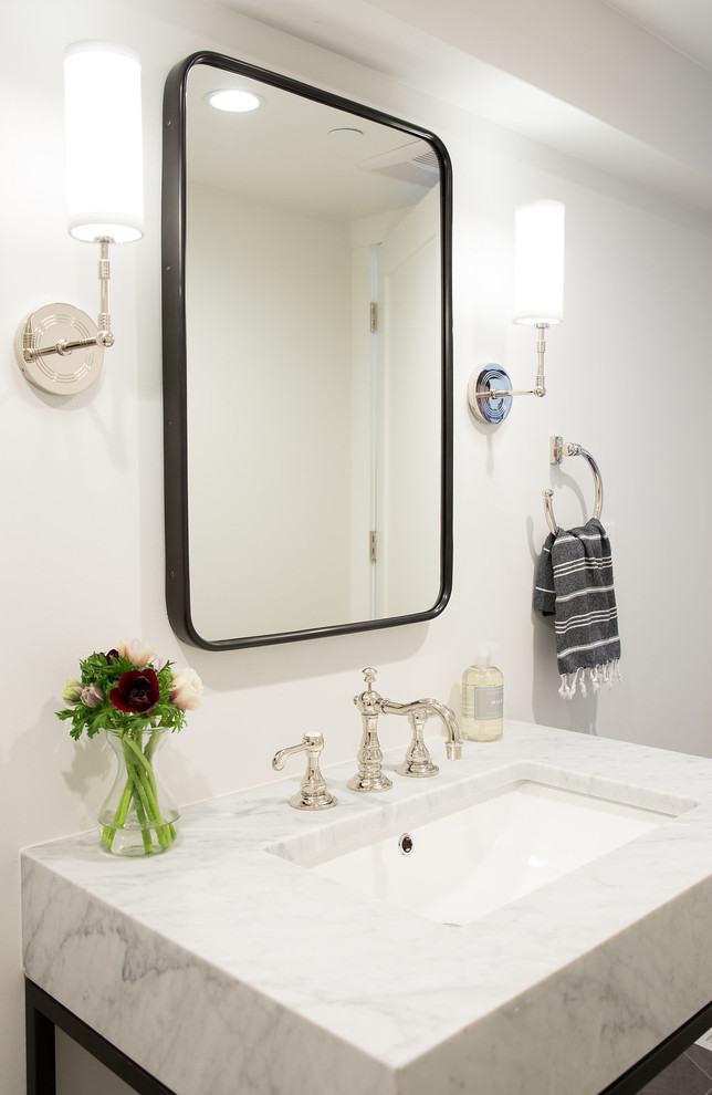 サンフランシスコにあるトランジショナルスタイルのおしゃれなトイレ・洗面所 (オープンシェルフ、黒いキャビネット、白い壁、磁器タイルの床、アンダーカウンター洗面器、大理石の洗面台、グレーの床) の写真