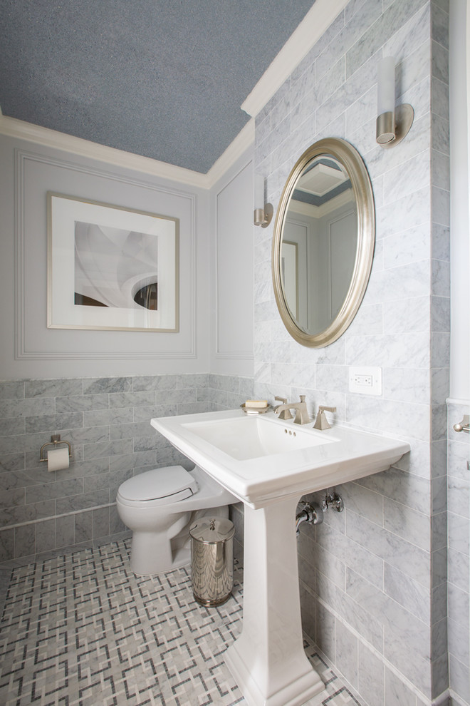 Powder room - mid-sized transitional gray tile, white tile and marble tile marble floor and gray floor powder room idea in DC Metro with a one-piece toilet, gray walls and a pedestal sink