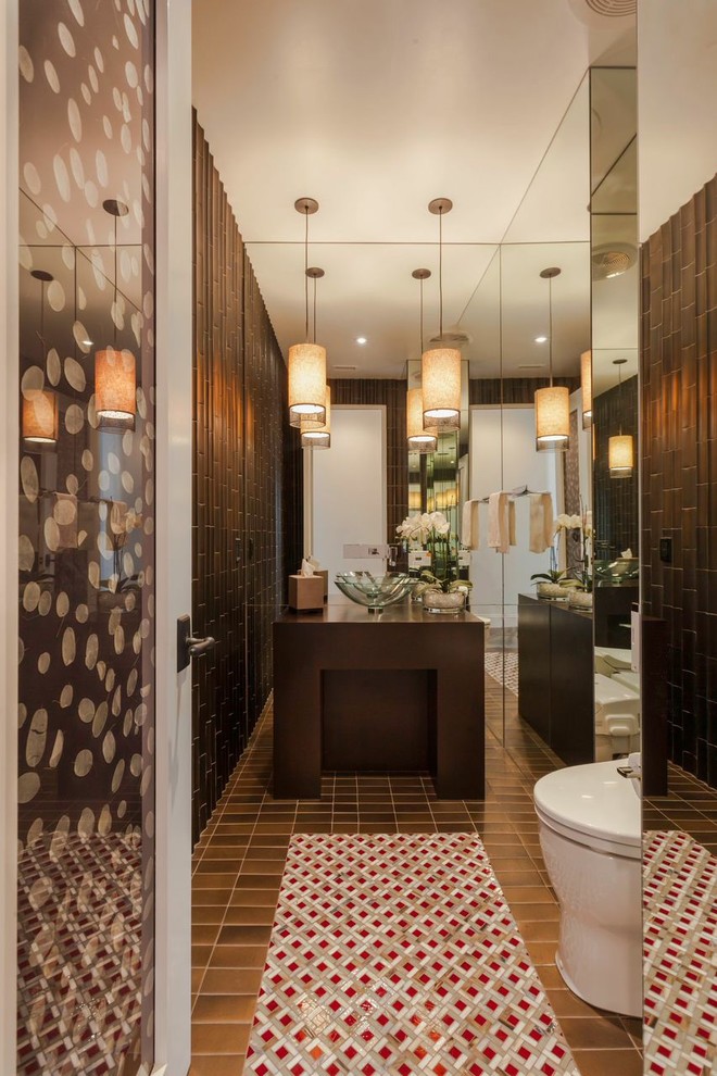Design ideas for a medium sized contemporary cloakroom in Los Angeles with a vessel sink, brown tiles, ceramic tiles, brown walls, mosaic tile flooring, dark wood cabinets, wooden worktops and brown worktops.