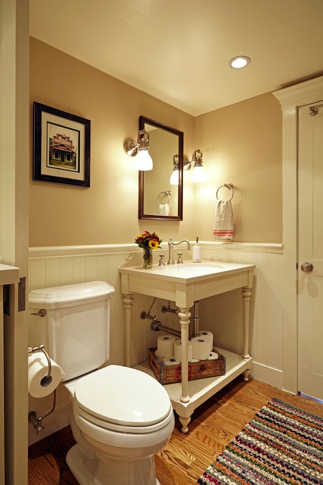 Inspiration for a small timeless medium tone wood floor powder room remodel in Los Angeles with a two-piece toilet, beige walls, an undermount sink, quartz countertops, open cabinets and white cabinets
