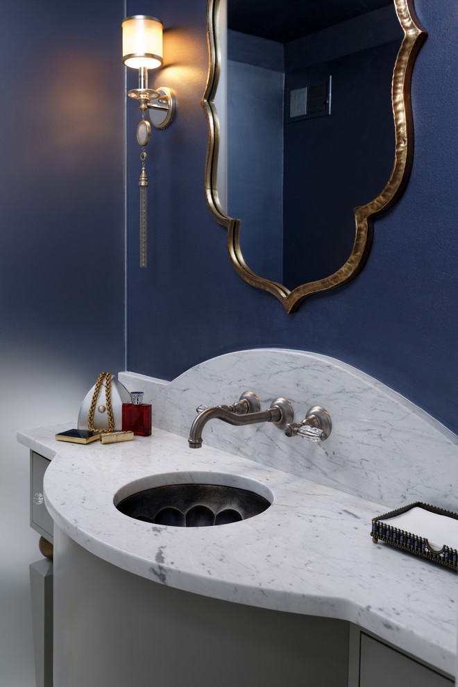 Photo of a mediterranean cloakroom in DC Metro with freestanding cabinets, grey cabinets, white tiles, marble tiles, blue walls, marble flooring, a submerged sink, marble worktops, white floors and white worktops.