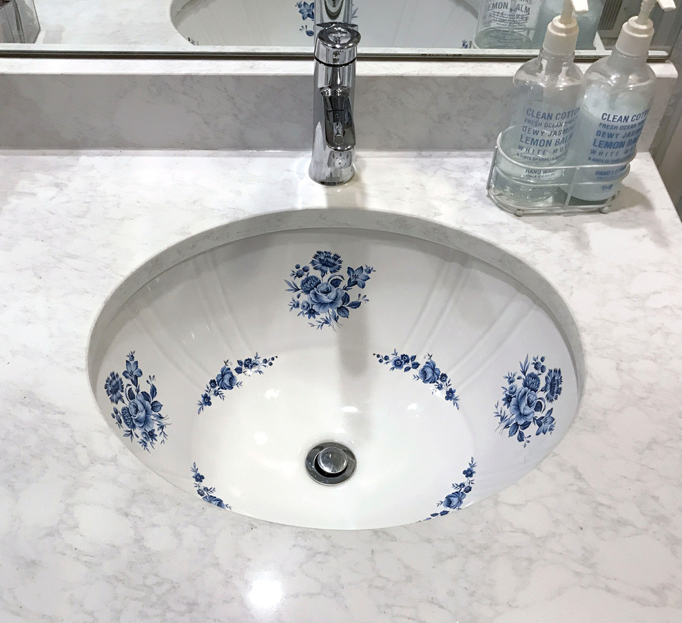 Foto di un bagno di servizio chic di medie dimensioni con lavabo sottopiano, top in marmo e top bianco