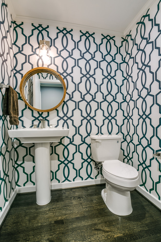 Inspiration for a small traditional cloakroom in Dallas with a two-piece toilet, multi-coloured walls, dark hardwood flooring and a pedestal sink.