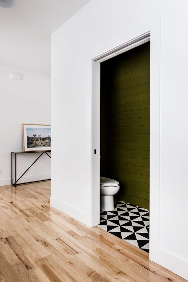 This is an example of a small contemporary cloakroom in Grand Rapids with green walls, ceramic flooring and multi-coloured floors.