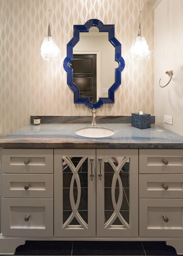Inspiration for a mid-sized contemporary powder room remodel in Houston with glass-front cabinets, beige cabinets, beige walls, an undermount sink, quartzite countertops and multicolored countertops