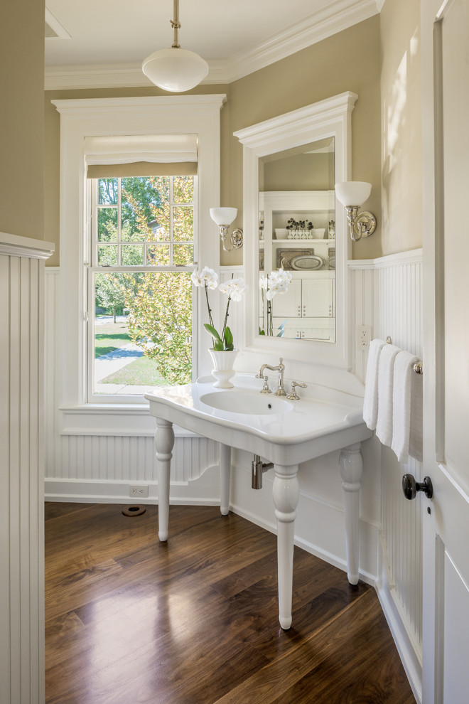 Design ideas for a traditional cloakroom in Providence with dark hardwood flooring, a console sink and brown floors.